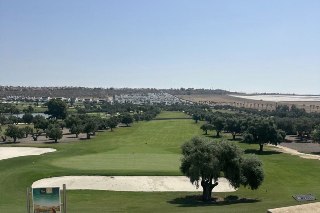 Fairway lined with olive trees at La Finca Golf, Algorfa