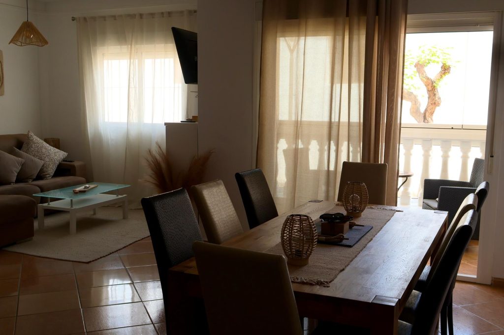Bright open plan lounge and dining area at The GolfBase