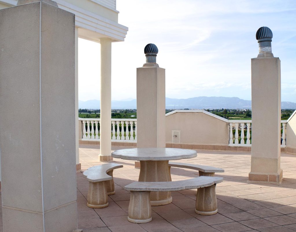 Communal roof terrace with seating and views to the mountains