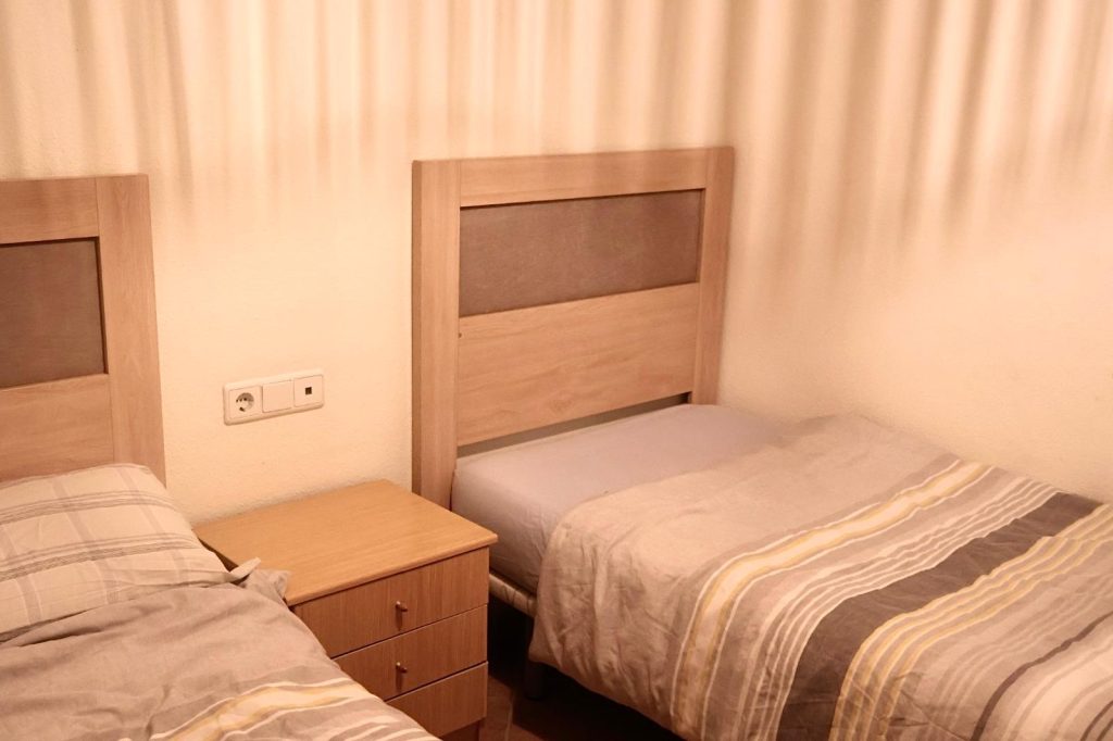Twin beds with bedside table